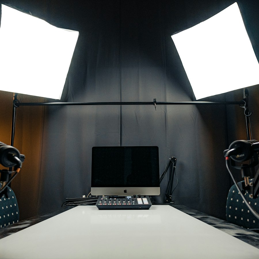 The podcast studio: microphones, headphones and soft lights around the recording table